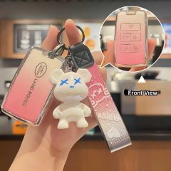 Land rover key cover with gradient pink design, featuring a cute bear charm and front view of the remote buttons.