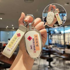 A hand holds a gac trumpchi m8 zongshi key cover, featuring elegant chinese characters and a front view inset showcasing its ...