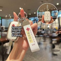 A hand holds a dongfeng renault key cover for koleos, captur & e-nose, featuring a white design with smooth sailing, wealth f...
