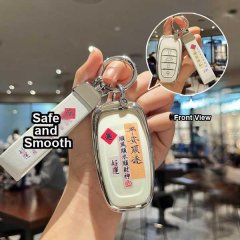 A hand holds a sleek, white key cover for red flag vehicles, featuring elegant chinese characters and a red diamond emblem. t...