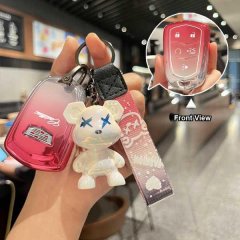 A hand holds a red cadillac key cover with a bear-shaped keychain, showcasing its front view and sleek design for models like...