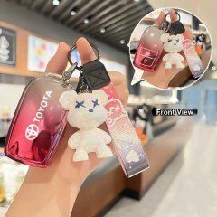 Stylish toyota key cover featuring a gradient red design and a cute bear charm, perfect for camry, rav4, corolla, and more.