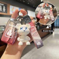 A hand holds a roewe 360 plus key cover featuring a white bear charm with blue eyes and a patterned strap, showcasing front v...