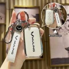 Hand holding a wuling xingchen 2022 premium leather key cover, showcasing the front design with sleek silver accents and the ...