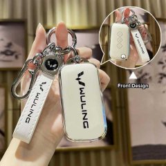 Hand holding a wuling hongguang s key cover, featuring a sleek white leather design with a front logo and functional keychain...