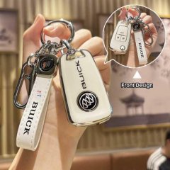 A hand holds a white buick key cover with a sleek design, featuring the buick logo and a matching wrist strap, shown in front...