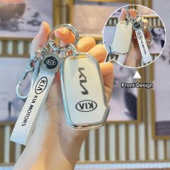 A hand holds a white leather key cover sleeve for the kia seltos 2023+, featuring a sleek front design with the kia logo and ...