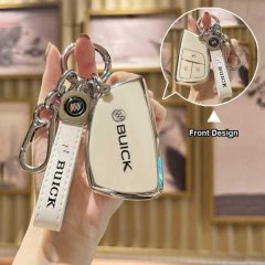 A hand holds a sleek, white leather key cover for the buick enclave plus, featuring a silver buick logo and a matching lanyar...