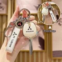 A hand holds a mitsubishi oem-style flat key cover, showcasing its front design with the iconic logo and mitsubishi text, pai...