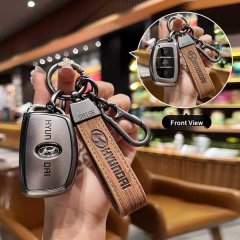 Hand holding a hyundai key cover with leather strap, showcasing front view of the sleek design for elantra, ix35, and avante ...