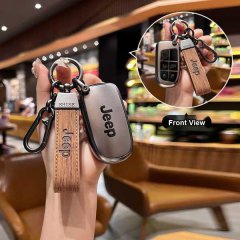 A hand holds a jeep leather key cover with a wooden strap, showcasing its front view and sleek design for grand cherokee and ...