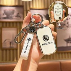 A hand holds a sleek white mg gt key cover for roewe 360 plus & w5 w4, featuring the morgan logo and a matching leather strap...