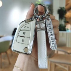 A hand holds a kd blade key cover for ds iron, featuring a sleek white tpu soft case with a decorative keychain and numbered ...