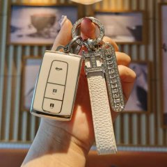 A hand holds a sleek, white toyota crown & prius key cover (12th gen, 2005-2008) with a slim design, featuring a leather stra...
