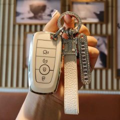 A hand holds a stylish white ford key cover with a leather strap and diamond-encrusted keychain, designed for mondeo, focus, ...