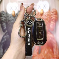 A hand holds a sleek infiniti key cover set, featuring a black leather strap with the infiniti logo and a matching key fob, d...
