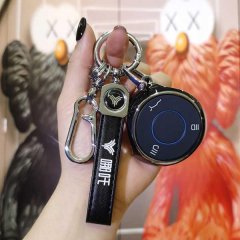 A hand holds a nio v key cover for nev 2022, featuring a sleek black leather strap with the nio logo and a modern key fob des...