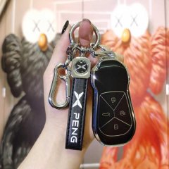 A hand holds a sleek xiaopeng p7 key cover, featuring a premium leather strap with peng branding and a modern, protective des...