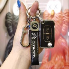 A hand holds a sleek citroen key cover with a leather strap and carabiner, designed for models like the c4 picasso, 308, 408,...