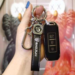 A hand holds a sleek baojun key cover, featuring a premium leather shell with a metallic logo and carabiner, designed for 530...