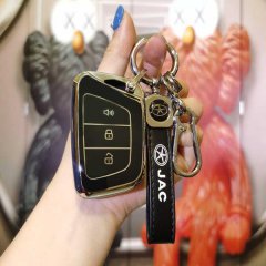 A hand holds a sleek jac key cover with a black and gold design, featuring buttons for lock, unlock, and alarm, attached to a...