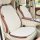 Puff & co. all-season car seat cushion in cream, featuring a quilted design for comfort and breathability, shown installed on...