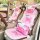 Cute cat winter cushion featuring plush pink and white design with playful meow text, perfect for cozy car seating.