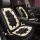 Elegant camellia floral winter cushion with plush texture, featuring a black base and cream floral design, perfect for cozy c...