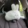 Adorable plush rabbit car headrest pillow, perfect for all-season comfort and style in your vehicle.