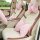 Elegant car interior featuring a plush, pink rabbit fur rose headrest and matching neck pillow, perfect for winter comfort.