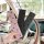 A hand holds a pink polka dot seat belt protector, with two more in black and gray, displayed inside a car for comfort and st...
