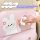 A hand wipes a pink leather car seat kick pad featuring cute bear and rabbit designs, highlighting its easy-to-clean surface.