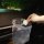 A hand holds a clear plastic bag with small items inside, showcasing the car cartoon mini hooks designed for invisible dashbo...