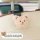 Cute beige teddy bear car hook attached to a seat back, featuring a soft plush design and black clip for multifunctional use.