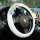 Adorable lamb wool steering wheel cover with colorful floral design, soft and non-slip for enhanced driving comfort.