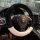 Black and white winter rabbit fur steering wheel cover for a porsche, providing warmth and a non-slip grip in a luxurious car...