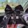 A hand holds a black and white checkered bamboo charcoal car sachet adorned with a decorative bow, crystal charm, and best wi...