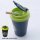Portable blue and green flame-retardant car ashtray with lid, made of abs material, featuring a cigarette resting on the open...