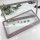 Elegant stainless steel license plate frame adorned with sparkling rhinestones, accompanied by screws and decorative caps, pe...