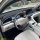 Interior view of the wuling xingyuan 2025 dashboard, featuring a sleek steering wheel with geome branding, modern digital dis...