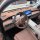 Interior view of the wuling binguo s showcasing a tan dashboard sun shade mat, modern steering wheel, and digital display.