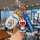 A hand holds a doraemon-themed car key cover and matching keychain, featuring a white oval case with doraemons image and a bl...