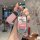A hand holds a stylish key cover featuring patrick star from spongebob, with a pink strap and hi! text, designed for kia k3 a...