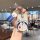 A hand holds a doraemon-themed key fob protector for the xpeng mona m03, featuring a cute design with the iconic blue robot c...