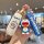 Hand holding a gac aion y plus key cover featuring a doraemon design, including a white case with blue accents and a matching...