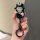 A hand holds a volkswagen key cover featuring a cute cartoon character in a hat, designed for models like polo, santana, and ...