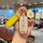 A hand holds a stylish yadea m16 car key cover with a yellow strap and a decorative egg-shaped charm, featuring the phrase ev...