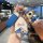 A hand holds a changan deep blue s05 key cover featuring a cartoon dachshund design with a blue strap and a matching plush ke...