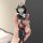 A hand holds a stylish key cover featuring a cartoon character in a helmet, holding a small bear, with get rich text on the s...