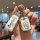 A hand holds a doraemon-themed car key cover for toyota vios models, featuring a cute design with the iconic blue robot and s...